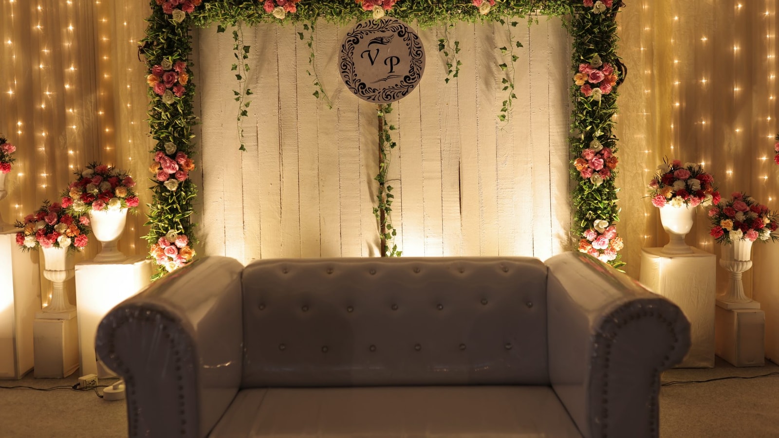 A Decorated Wedding Stage With A Sofa.
