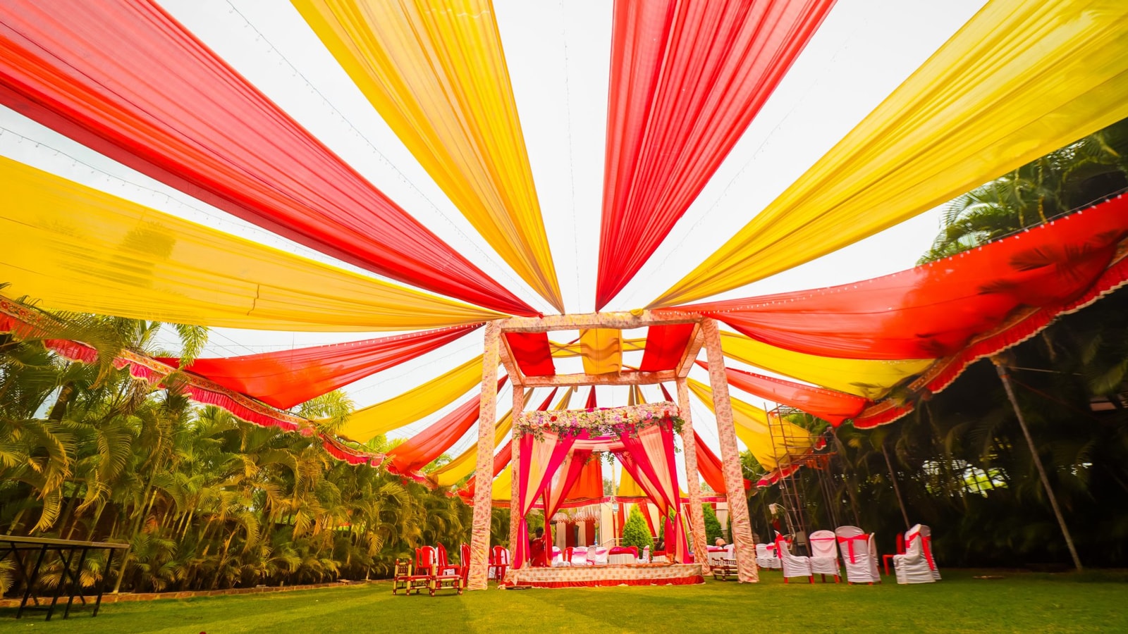 Colorful Outdoor Wedding Stage (mandap) With Radiant Red And Yellow Fabric Canopy,
