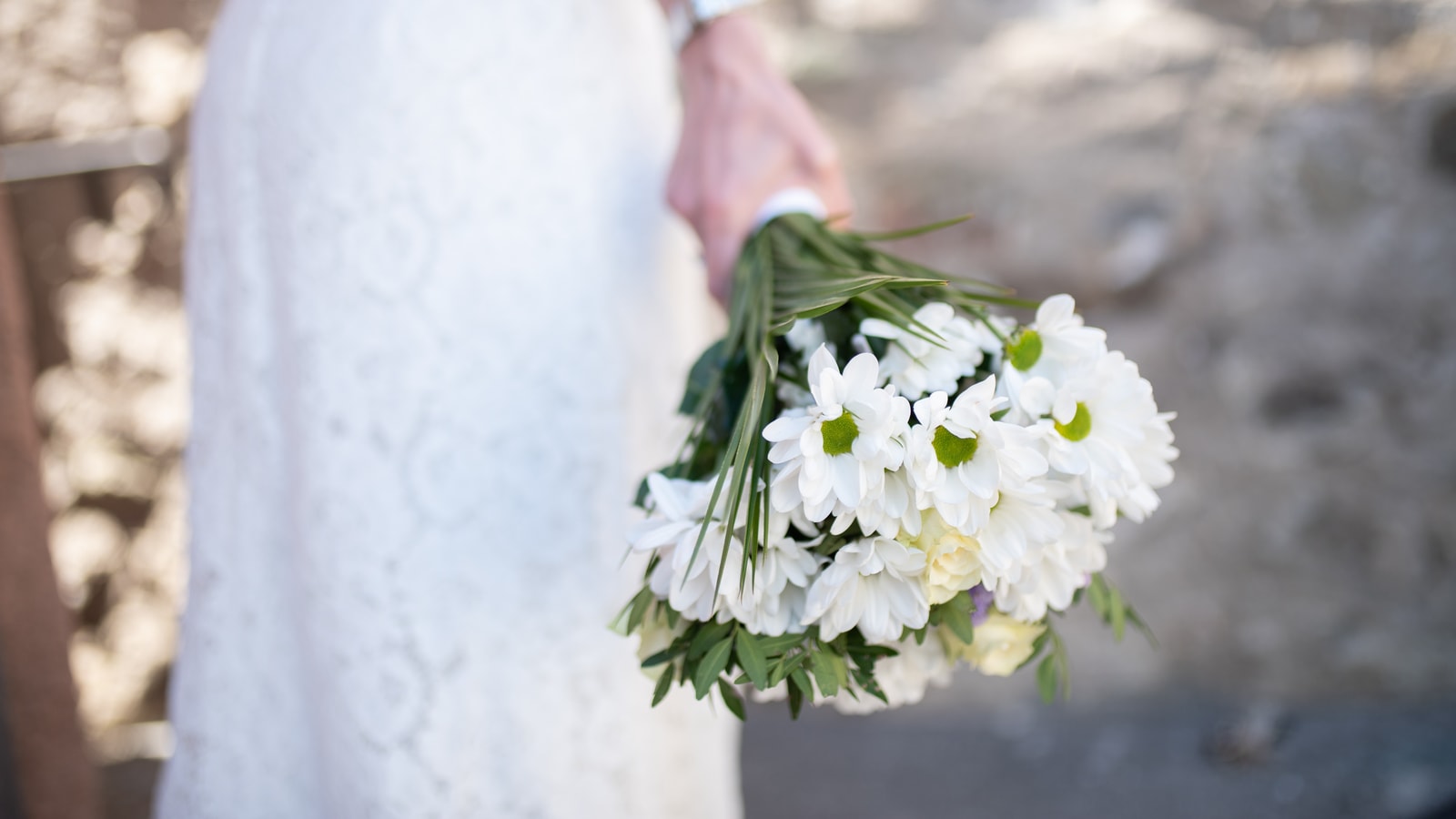 Wedding stage decor with flowers and warm event lighting