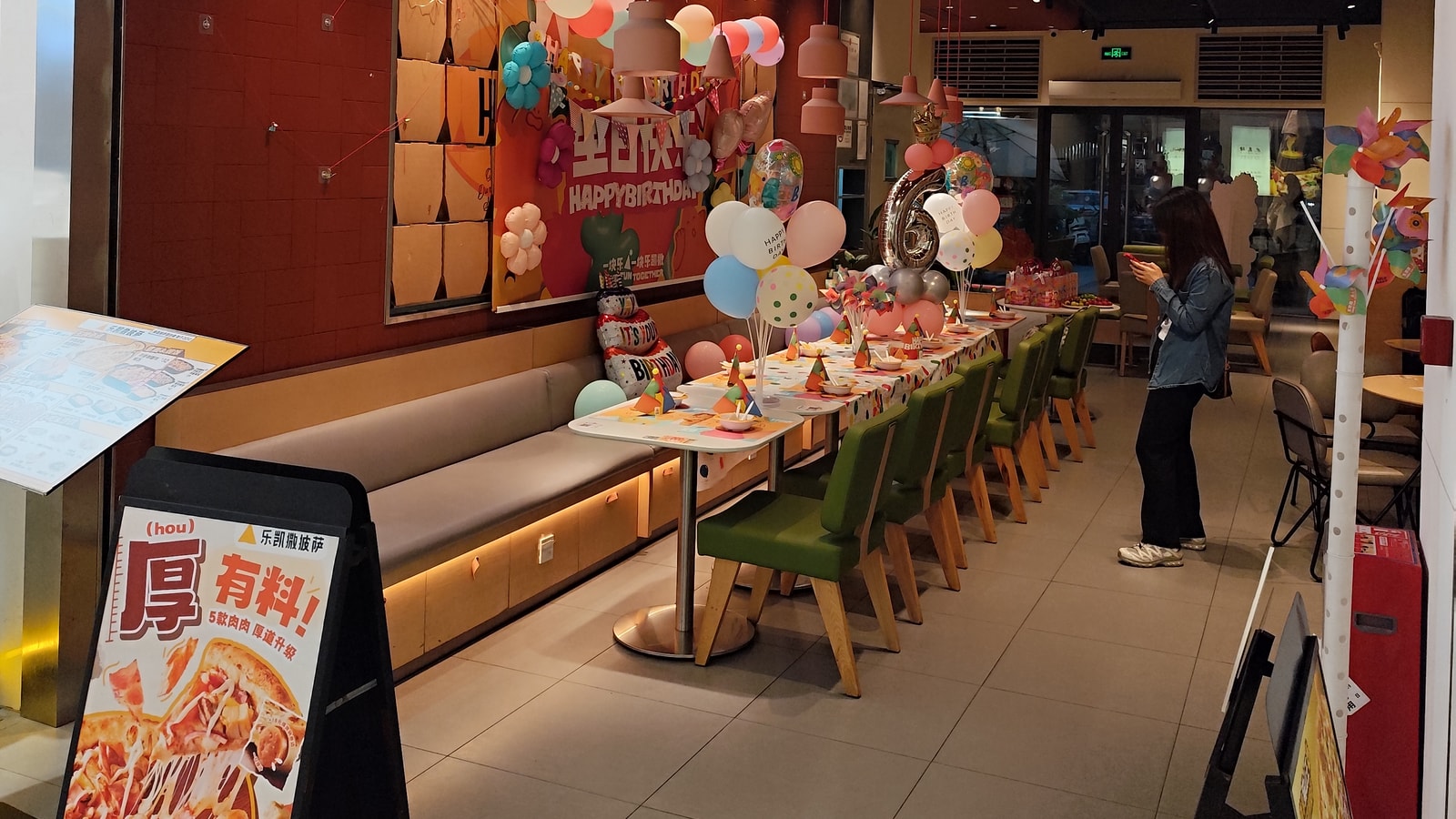 Birthday party backdrop with balloons and celebration decor