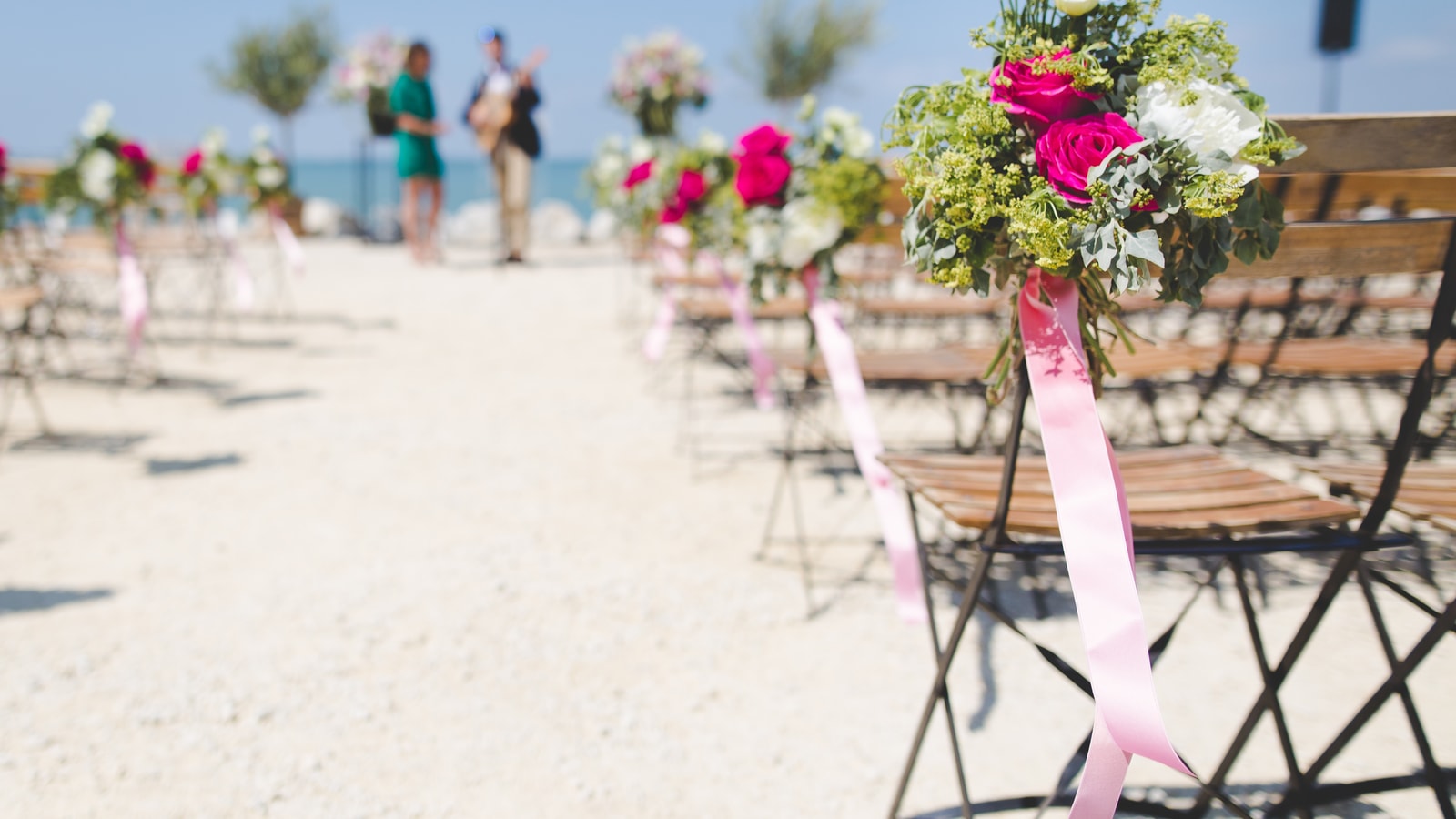Wedding stage decor with flowers and warm event lighting