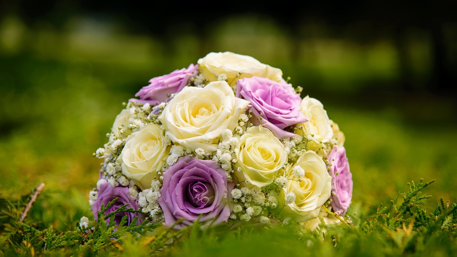 Wedding stage decor with flowers and warm event lighting